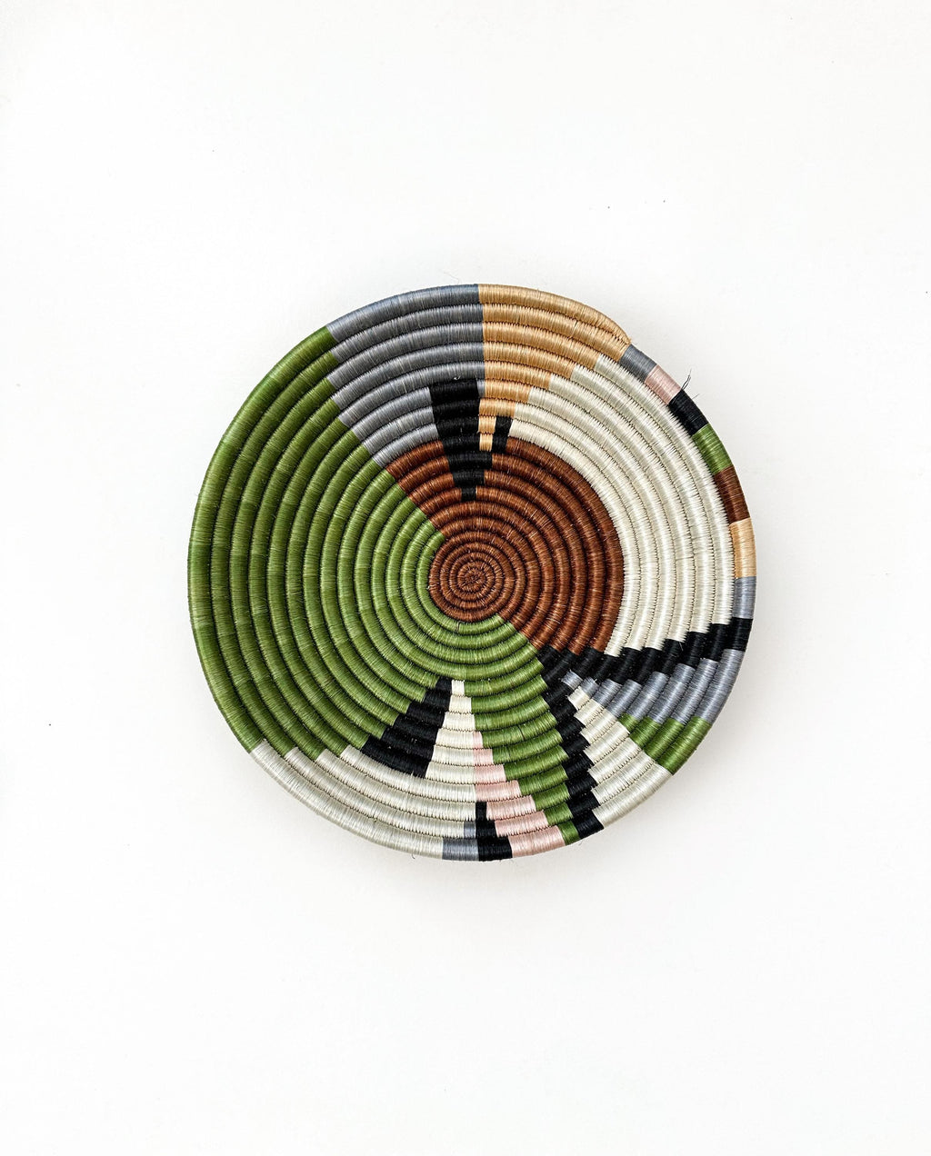 Woven colorful bowl. Rwanda Basket with abstract pattern in green, brown and white color