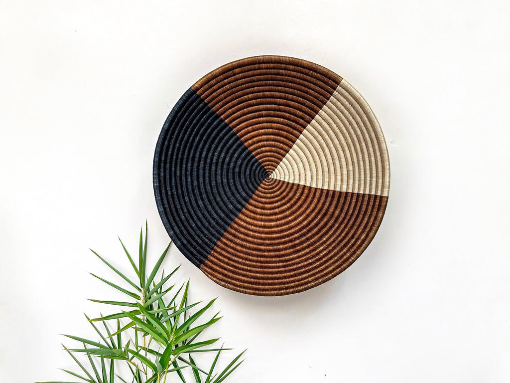 large 16 inch woven wall basket, in earthy tone shades of brown, beige and black. African wall basket